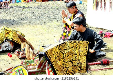 Pemalang, August 2022. Two Young Men Praying Before The Horse Braid Attraction