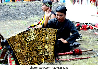 Pemalang, August 2022. Two Young Men Praying Before The Horse Braid Attraction