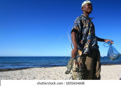 Pemba, Mozambique - October 6, 2006: young fisherman selling the catch of the day (fresh lobsters) on the beach at Pemba, Cabo Delgado, Mozambique.