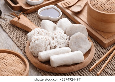Pempek is a food made from gently ground fish meat mixed with starch or sago flour, as well as a composition of several other ingredients such as eggs, crushed garlic, flavorings and salt. - Shutterstock ID 2394924497