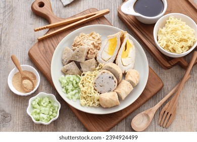Pempek is a food made from gently ground fish meat mixed with starch or sago flour, as well as a composition of several other ingredients such as eggs, crushed garlic, flavorings and salt. - Shutterstock ID 2394924499
