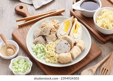 Pempek is a food made from gently ground fish meat mixed with starch or sago flour, as well as a composition of several other ingredients such as eggs, crushed garlic, flavorings and salt. - Shutterstock ID 2394924503
