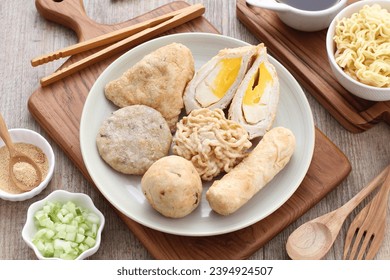 Pempek is a food made from gently ground fish meat mixed with starch or sago flour, as well as a composition of several other ingredients such as eggs, crushed garlic, flavorings and salt. - Shutterstock ID 2394924507