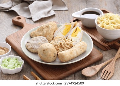 Pempek is a food made from gently ground fish meat mixed with starch or sago flour, as well as a composition of several other ingredients such as eggs, crushed garlic, flavorings and salt. - Shutterstock ID 2394924509