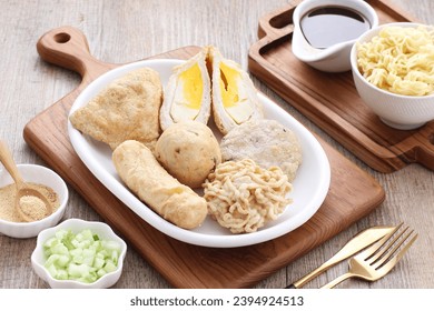 Pempek is a food made from gently ground fish meat mixed with starch or sago flour, as well as a composition of several other ingredients such as eggs, crushed garlic, flavorings and salt. - Shutterstock ID 2394924513