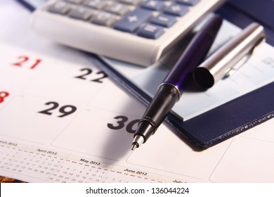 Pen, Calculator, Calendar and Cheque Book Photo of a pen, calculator, calendar and cheque book
