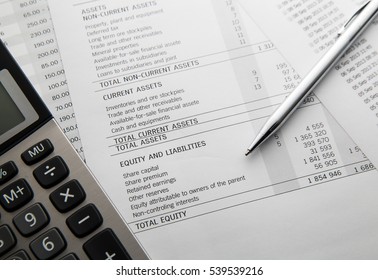 Pen, calculator On the financial account documents. Financial concept