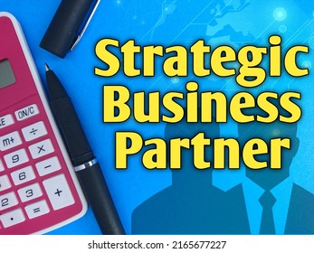 Pen, Calculator And Text Written Strategic Business Partner On Blue Background 