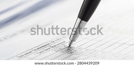 pen checking financial documents and accounting reports. Business, finance and audit.
