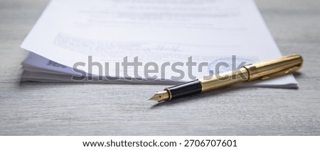 Pen and contract on the table.