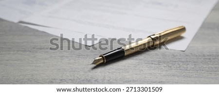 Pen and contract on the table.