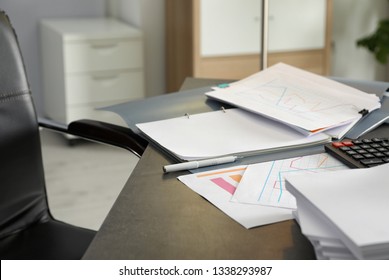 Pen, different documents and calculator on office table