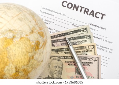 Pen, dollar, globe and contract. Profitable business contract concept. Close-up