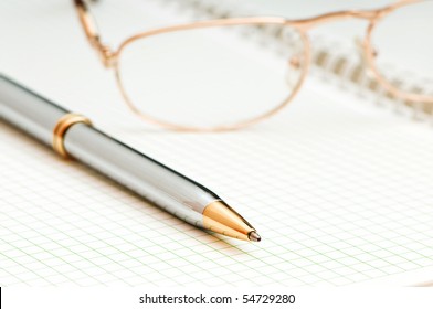 Pen and eye glasses on the page - Powered by Shutterstock