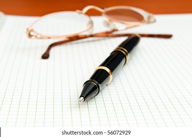 Pen and eye glasses on the page - Powered by Shutterstock