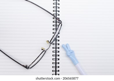 Pen glasses and notebook
