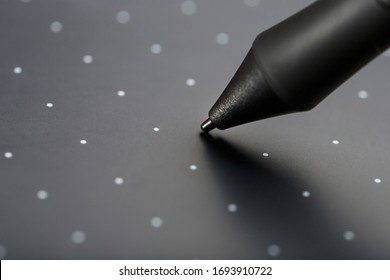 Pen and graphic tablet close-up on a gray textural background. Gadget for working as a designer, artist and photographer.
