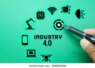 pen in hand and technology icons and the word Industry 4.0. Industry Infographics 4.0