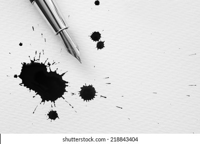 Pen and inkblots on a paper.