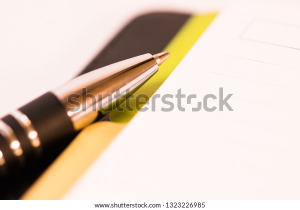 Pen laying on notebook\
and dividers