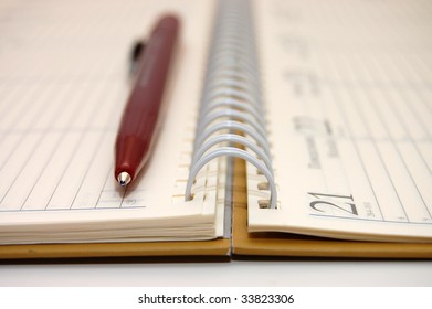 pen lying on opened notebook