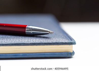 Pen and notebook close up