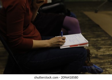 pen and notebook in hand