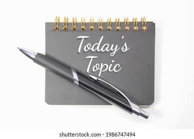 pen, notebook with today’s topic words and white background - Shutterstock ID 1986747494