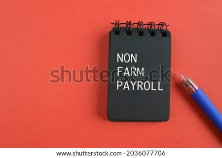 Pen and notebook written with text NON FARM PAYROLL