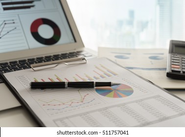 Pen On Business Graphs Report, Computer On Desk Of Financial Advisor. Accounting Background Abstract Concept.