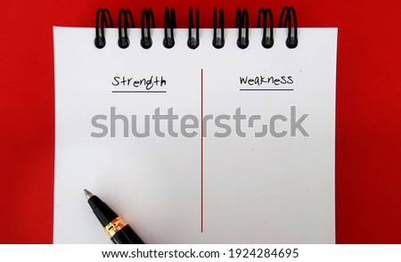 Pen on note book with text written STRENGTH and WEAKNESS - concept of making personal defined lists of strong and weak points for a job interview or self improvement