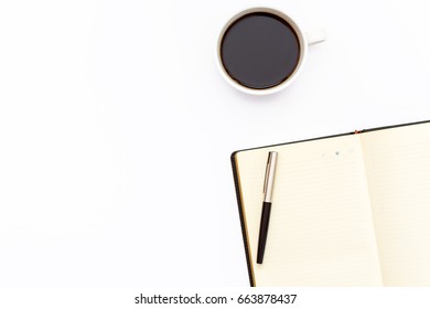 Pen On The Open Day Planner And A Cup Of Black Coffee On A White Background. Minimal Business The Concept Of The Workplace. Top View. Flat Lay.