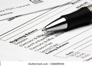 A pen on top of a bank statement. - Shutterstock ID 1586089696