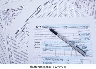 Pen On US TAX Form Background. 
 Tax Day Concept