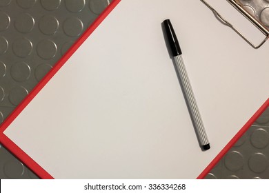 Pen On White Paper,red Clipboard Background.