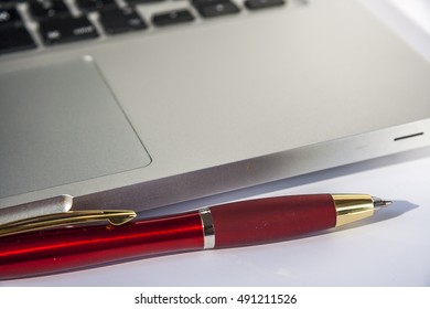 Pen And Open Laptop