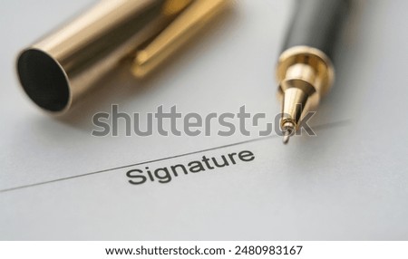 Pen over a field of a document to be signed. Pen tip close up on the place to sign on the document	
