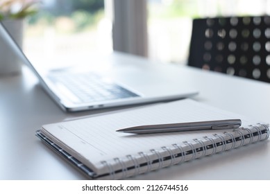 Pen, Paper Notebook And Laptop Computer On White Office Table With No People, Business Workspace, Blurred For Business Background