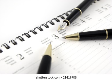 Pen and planner on white background - Shutterstock ID 21419908