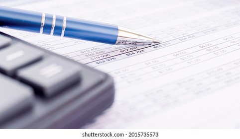 Pen Point On Bank Statement With Calculator