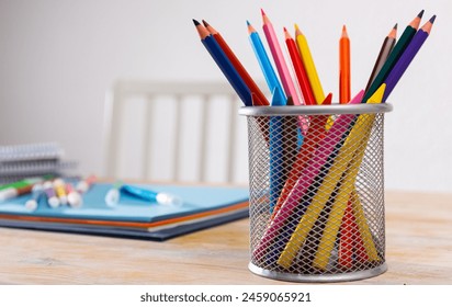 Pen pot with pencils, globe and school office stationery on table - Powered by Shutterstock