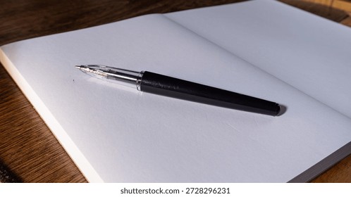 Pen resting on an empty notebook page, representing readiness, minimal workspace, creative potential, and calm preparation before writing.