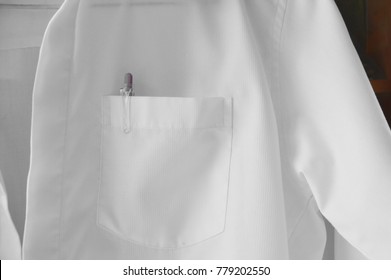Pen Stab In White Shirt Pocket Hanging On Wall