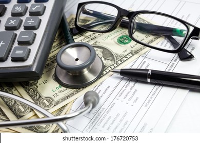 Pen stethoscope glasses and dollar on blank Patient information