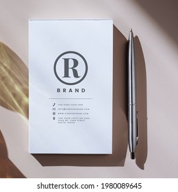 Pen and white notebook mockup