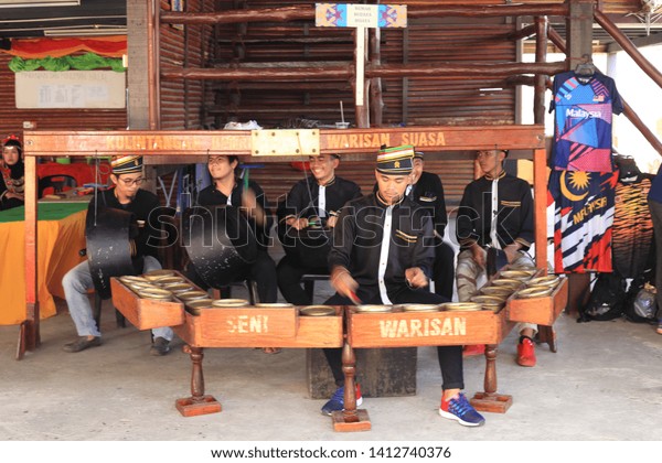 Penampang, Sabah, Malaysia, May 31, 2019 :\
Group of people in traditional costume playing traditional musical\
instruments during Pesta\
Kaamatan.