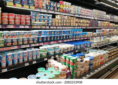 PENANG, MALAYSIA - 10 NOV 2021: Interior view of huge open refrigerator with various brands yogurt and dairy products in Village Grocer store. It is the coolest fresh premium supermarket in Malaysia.