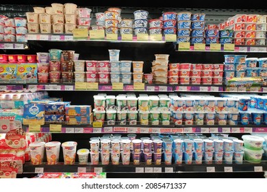 PENANG, MALAYSIA - 10 NOV 2021: Interior view of huge open refrigerator with various brands yogurt and dairy products in Village Grocer store. It is the coolest fresh premium supermarket in Malaysia.