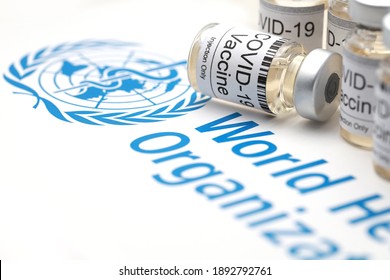 PENANG, MALAYSIA - 13 JAN 2021: Covid-19 Corona Virus 2019-ncov Vaccine Vials Medicine Drug Bottles With World Health Organization (WHO) As Background. Soft Focus Image.