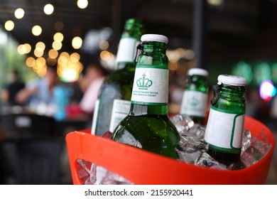 PENANG, MALAYSIA - 13 MAY 2022: View of Carlsberg brand of bottle beer in ice basket. Carlsberg is a global brewer, the company's headquarters is located in Copenhagen, Denmark.